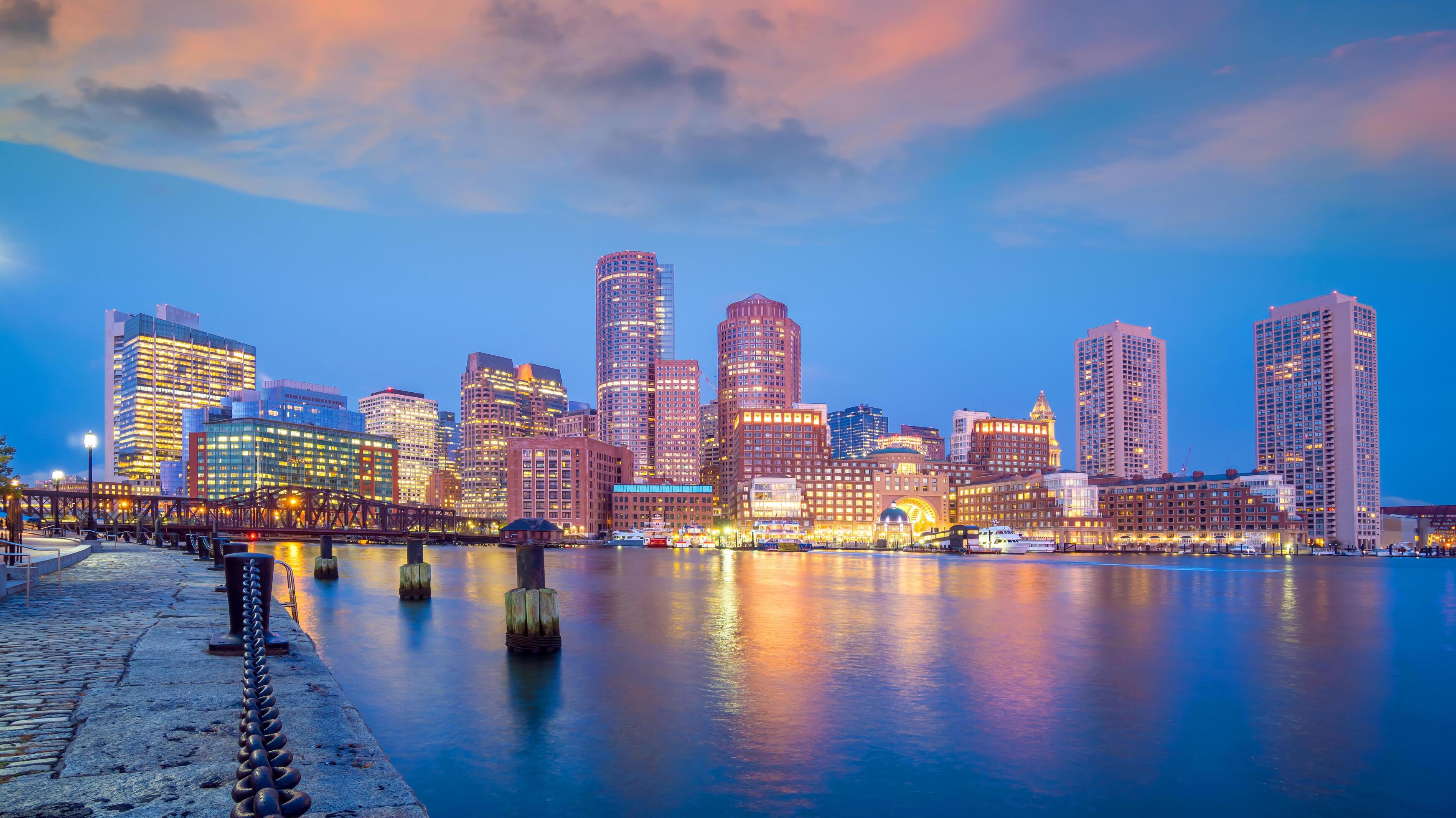 The Boston skyline at dusk, seen across the harbor